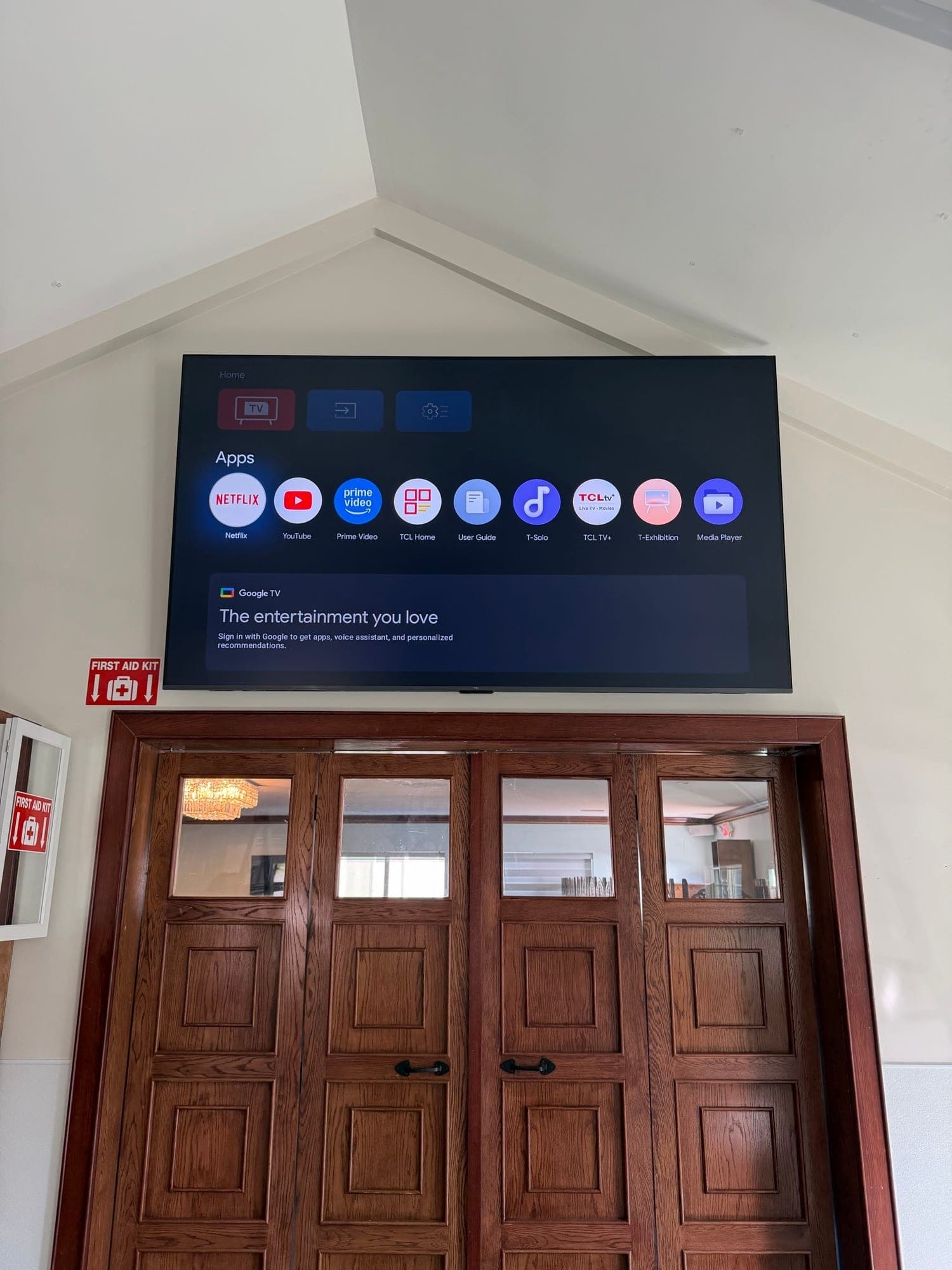 A wall-mounted TV with no visible cabling, mounted above door height
